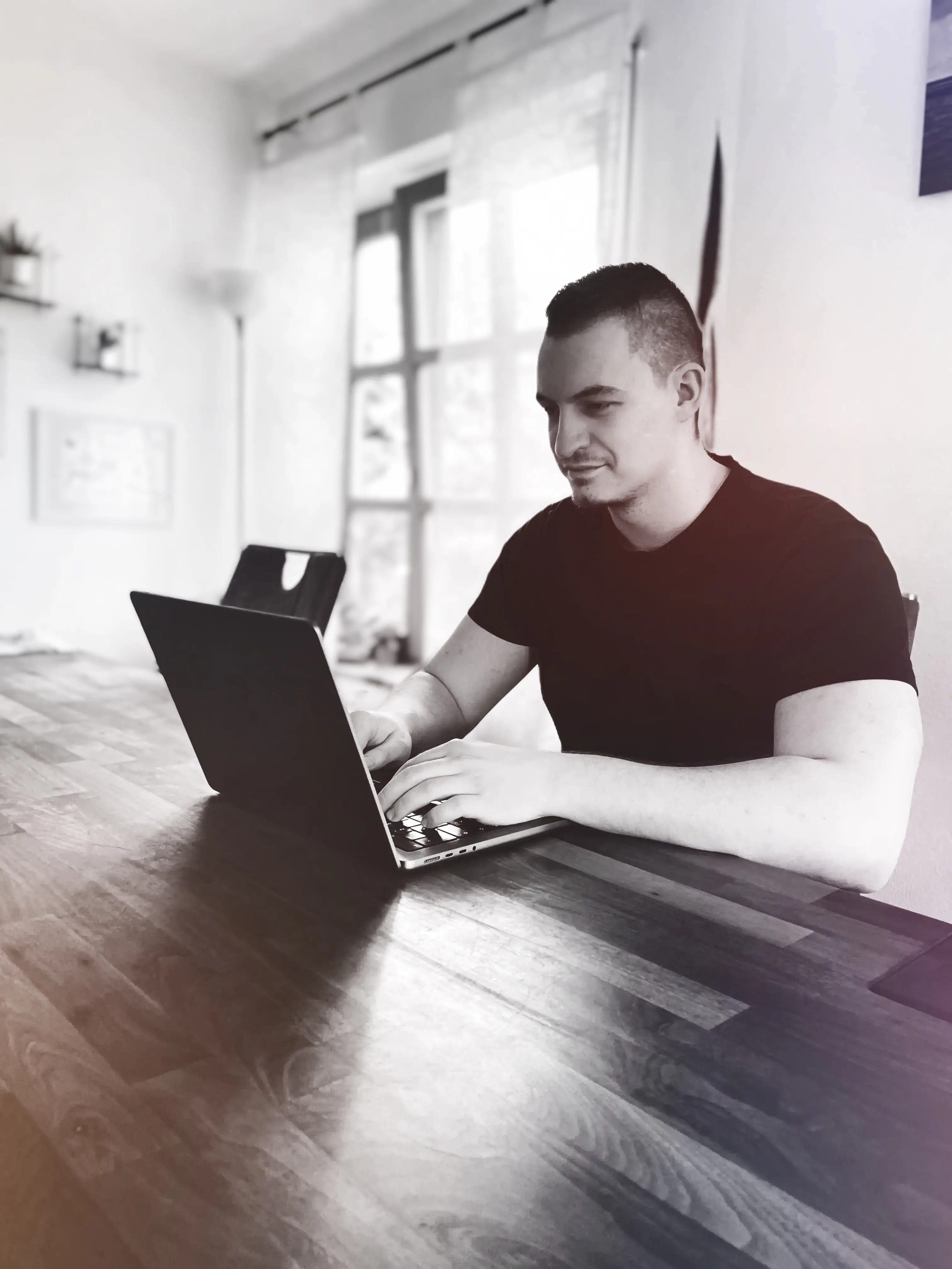 An image of a person sitting in front of a laptop.